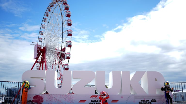 Young F1 fans dressed as Lando Norris, Charles Leclerc and Max Verstappen